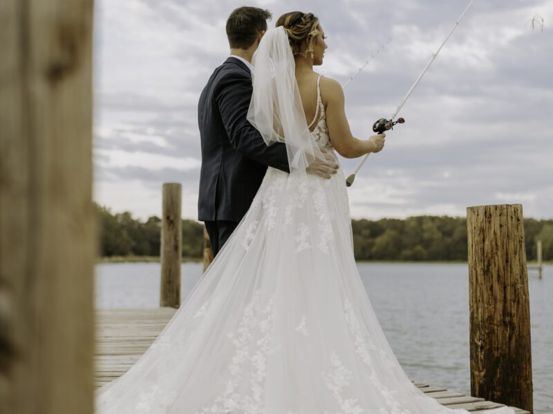 wedding couple fishing at lakeside dock