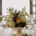 summer wedding ceremony with blue, peach, and white florals