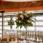 summer wedding ceremony with blue, peach, and white florals