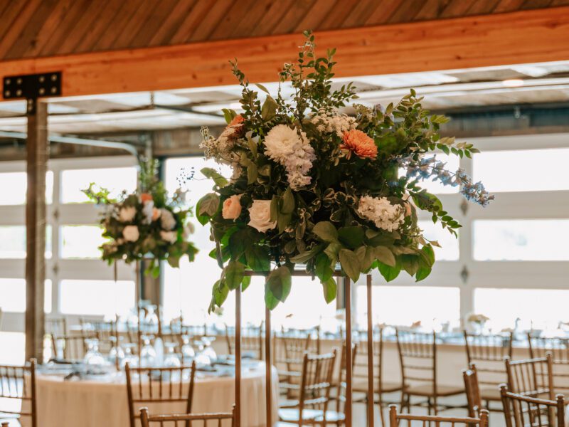 summer wedding ceremony with blue, peach, and white florals