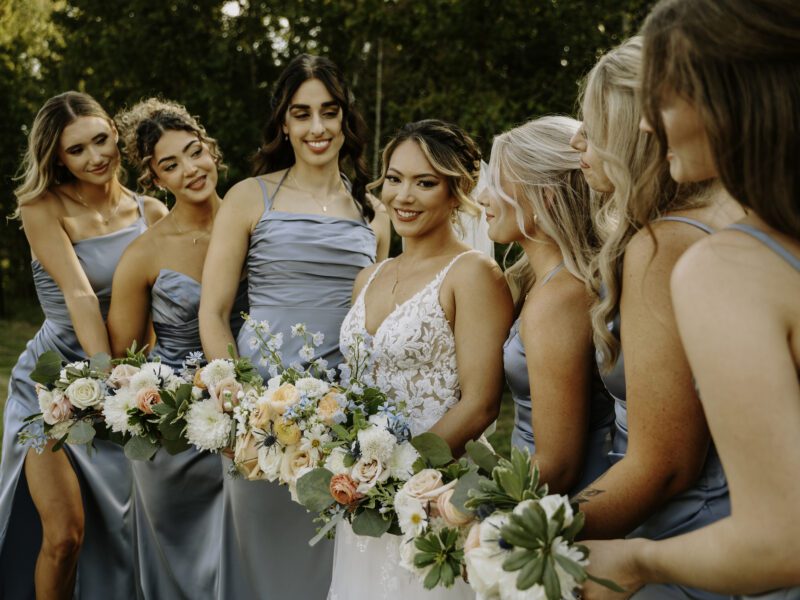 summer wedding ceremony with blue, peach, and white florals