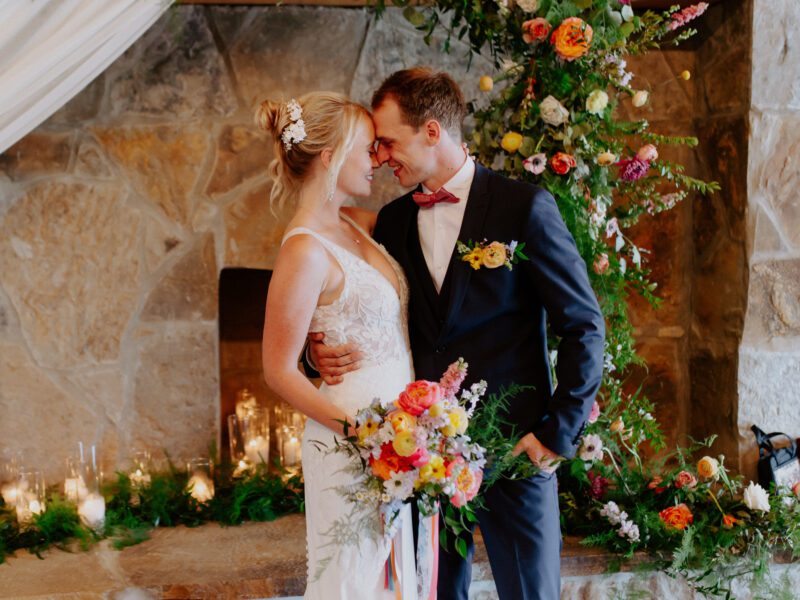 Colorful summer wedding reception at C&C by the Lake, with vibrant floral arrangements and a lakeside backdrop