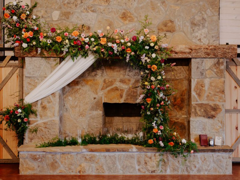 Stunning colorful in-house florals featuring bright summer blooms for a wedding at C&C by the Lake